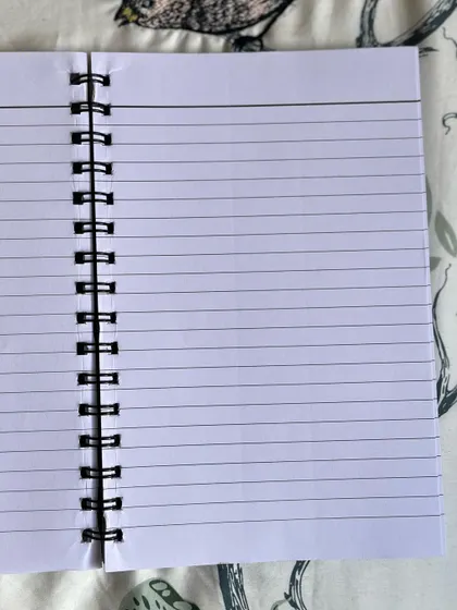 The inside of my A5 notebook, featuring clean, ruled pages ready for all your thoughts.