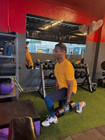 A client performs a dumbbell lunge, a fundamental movement pattern for building lower body strength and coordination.