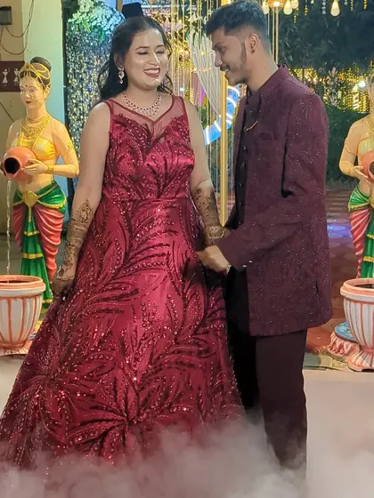 Make a grand entrance at your engagement party with this stunning red sequin gown. We can coordinate it with a matching Jodhpuri suit for the groom-to-be.