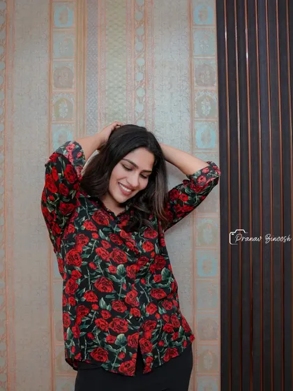 A beautiful portrait of actress Swasika Vijay, taken during our collaboration. She is pictured against a backdrop of elegant wallpaper and fluted paneling that we installed in her home.