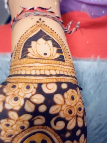 A close-up of a Diwali mehendi cuff, featuring a beautiful lotus design.