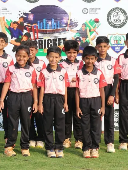 A junior team in pink and red poses for their official team photo at the RSCA League.