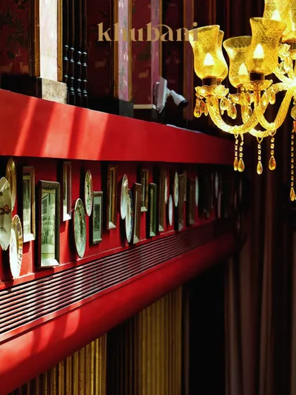 Welcome to Khubani, where the glow is golden and every corner feels like a page from a royal diary. The red walls and curated plate decor add to the unique, artful ambiance.