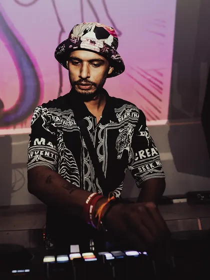 A focused shot of me at the decks, with the 'Salty' visuals projected behind me. Every gig is a chance to create a unique experience.