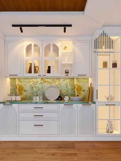 A frontal view of the elegant crockery unit, highlighting the arched glass doors and the beautiful contrast between the white cabinetry and the green marble.