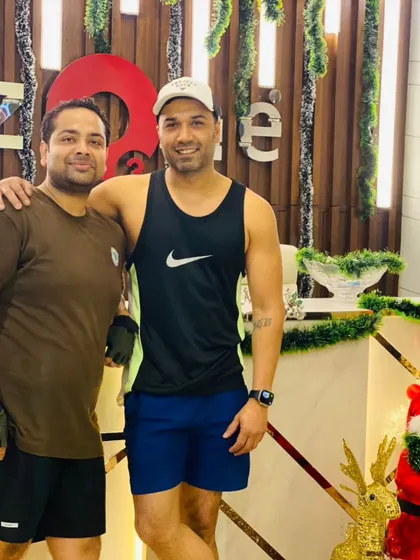 A member and trainer pose together, showcasing the strong relationships built within our fitness community.