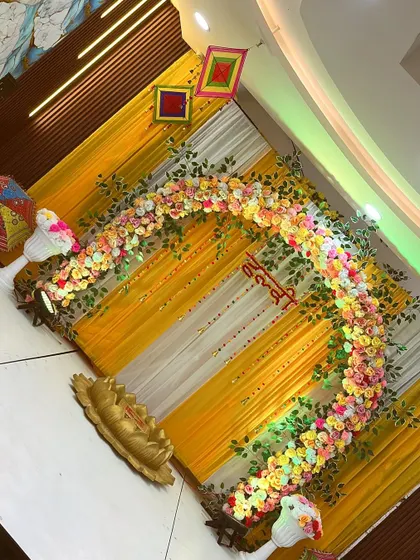 An overhead shot of the Haldi decor, showing the beautiful curve of the floral arch.