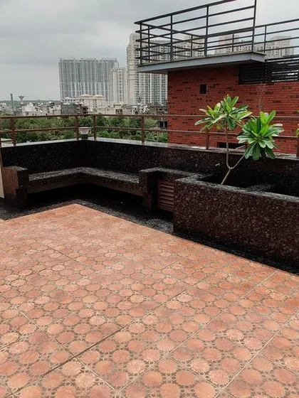 A completed view of the terrace, featuring built-in seating with planters and durable floor tiles. We transform empty rooftops into beautiful and usable spaces for relaxation and entertainment.