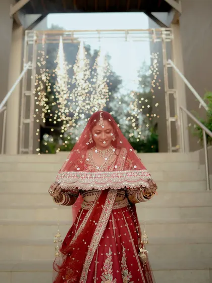 The bride's grand entrance, framed by sparkling lights, creating a magical and ethereal portrait.