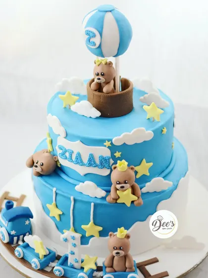 This is one of my most popular designs for a boy's first or second birthday. The two-tier cake features teddy bears, a toy train, a hot air balloon, and lots of stars.