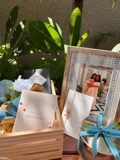 Another view of the "Sister Rakhi" hamper, showing the personalized cards and the thoughtful arrangement of gifts.