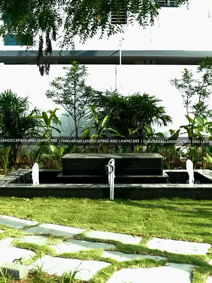A modern, multi-tiered water fountain crafted from black stone, providing a gentle, soothing sound and a sophisticated centerpiece for this garden.