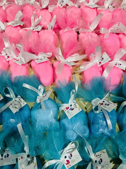 These are our popular baby shower return favors. We packed these cute baby feet and pram soaps, made with gentle goat milk base and pure almond oil, in pink and blue organza bags.