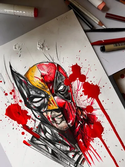 A close-up of the Deadpool and Wolverine artwork. This view highlights the details in the masks and the blend of yellow and red, achieved with Prismacolor pencils.