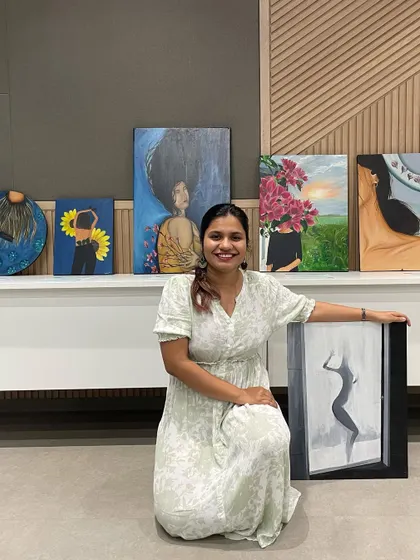 Me with my "Walking Towards Acceptance" series at my first in-person exhibition. These six canvases tell a visual tale of embracing my body.