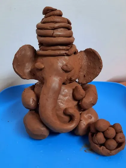 The finished eco-friendly Ganesha idol, complete with a bowl of modaks, ready for our celebration.