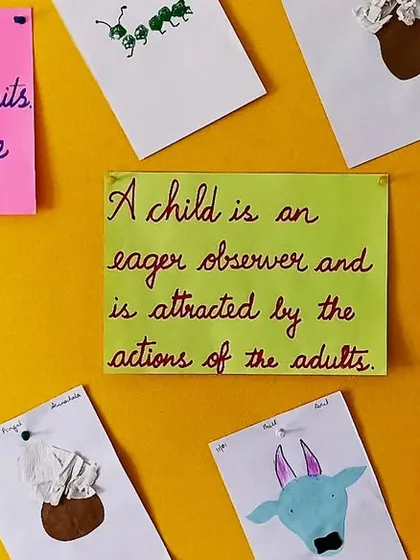 A display of children's work and Montessori quotes, set up for our parent-child observation sessions.