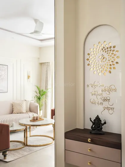 This mandir is a key highlight of the dining area, exuding divinity amidst modern luxury. The design features the Om symbol in golden letters and an inscribed mantra on a white arched panel.