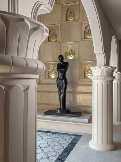 Another view of the sculpture, framed by classical columns and illuminated wall niches. This space was meticulously designed to create a sophisticated environment that showcases both exquisite jewellery and fine art.