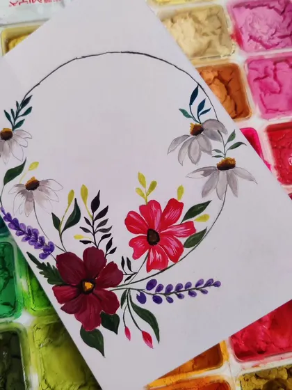 A floral wreath painted with gouache, laid over my paint palette. The colors are so rich and satisfying to work with.