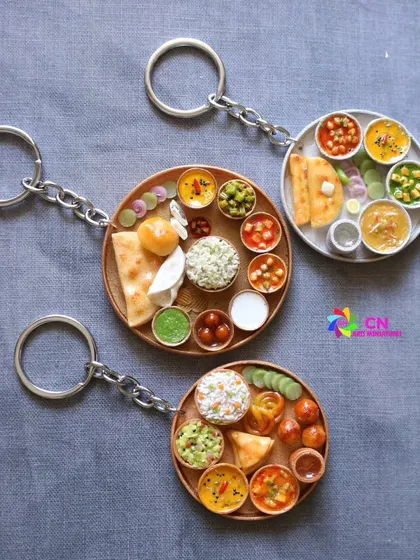 A set of beautiful thali keychains, showcasing both North and South Indian varieties. These make for wonderful, detailed gifts.