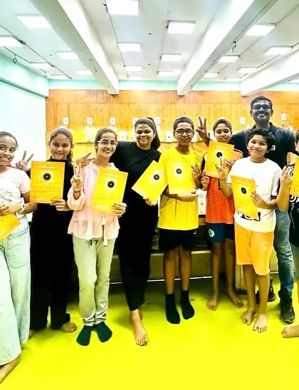 A group of smiling campers with their certificates and coaches. I make sure to celebrate the completion of the camp to give every child a sense of achievement.