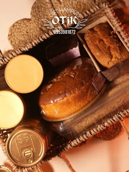 A top-down view of a rustic jute bag hamper for Diwali, filled with dry cakes and other treats. This packaging offers a unique, eco-friendly gifting option.