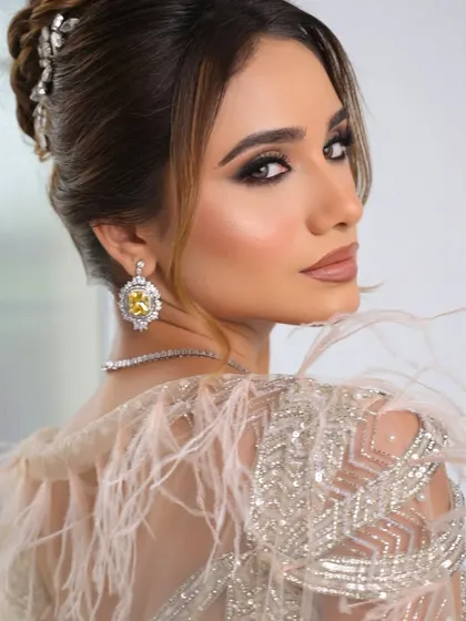 This shot highlights the beautiful hair updo, adorned with a crystal accessory, which adds another layer of sophistication.