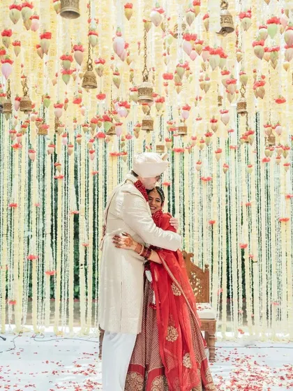 A duplicate of 302, capturing a sweet embrace under a floral canopy.