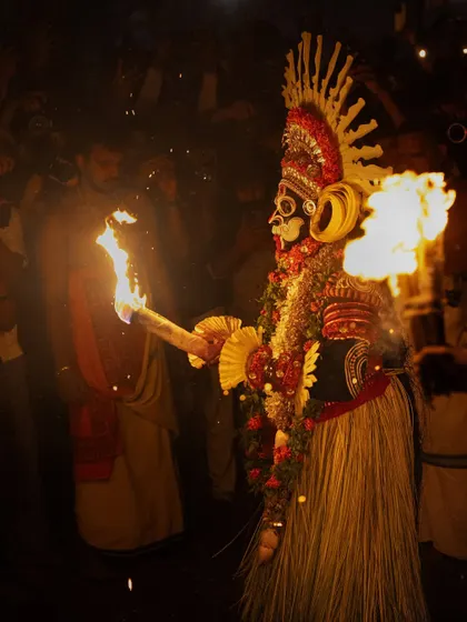A series showing the Karim Gullikan Theyyam performance, surrounded by devotees and fire. These images document the energy of the crowd and the deity's commanding presence during the ritual.