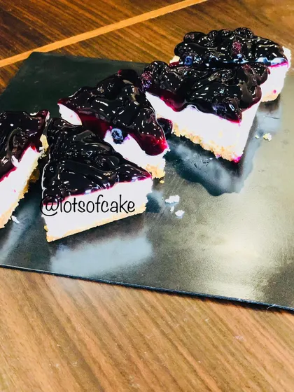 My blueberry cheesecake, sliced and ready to be served. The contrast between the dark blueberry topping and the white creamy filling is just beautiful.