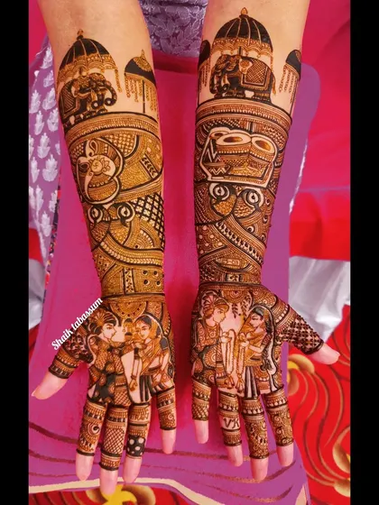 A festive bridal mehendi design featuring a couple's portrait, dhol players, and a majestic elephant. This artwork captures the celebratory spirit of an Indian wedding.