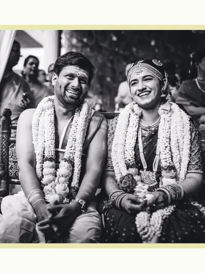 A classic black and white photograph of the couple sharing a heartfelt laugh during their wedding. These are the timeless, authentic moments we strive to capture.