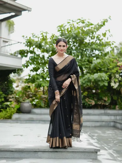 A full-length view of the black and gold saree, showcasing its elegant and commanding presence.