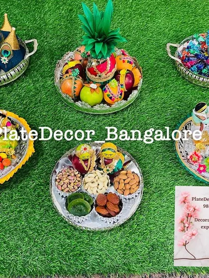 A collection of different seer varisai platters I created for a wedding, including the pineapple groom, peacock-feather coconuts, and various fruit and dry fruit arrangements.