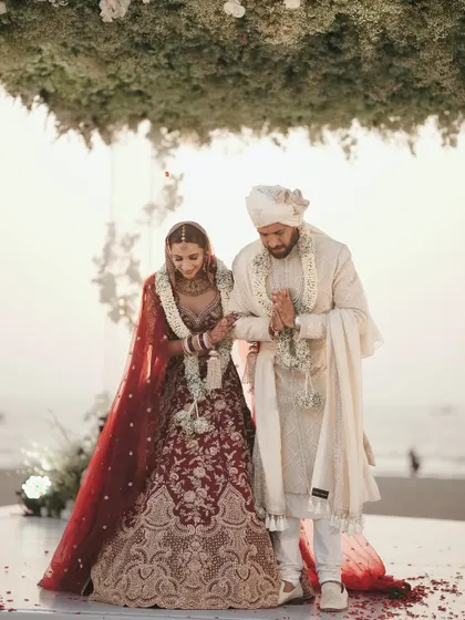Walking together after the pheras. The all-white outfits against the backdrop of the sea created a serene and elegant frame.