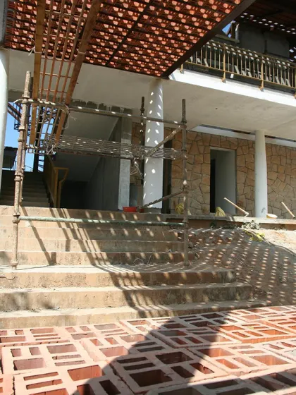Site stories from Chikmagalur show the raw beauty of a project in progress. The interplay of scaffolding, stone walls, and the shadows from the jali porch reveal the bones of the architecture before it's complete.