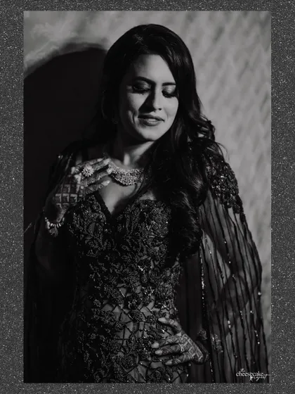 A soft, grainy black and white portrait of the bride, looking elegant and timeless.