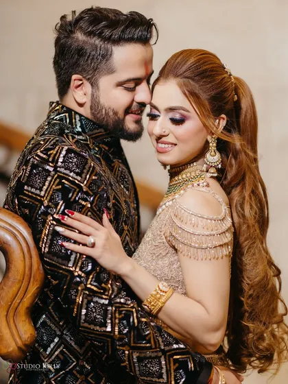 An intimate and romantic portrait of the couple on a staircase during their engagement party.