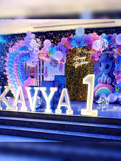 A closer look at the unicorn-themed stage, highlighting the light-up marquee letters and the adorable unicorn sitting on a rainbow, ready for the celebration.
