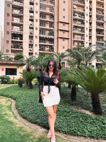 A stylish look with a sheer black top and a white ruched skirt from NewMe. This is a great outfit for a brunch or a day out.
