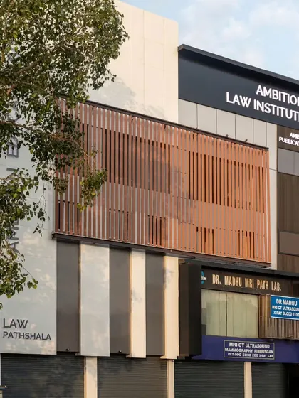 The completed facade of the Ambition Law Institute in Delhi. Our design solution provides a contemporary and professional identity that stands out in its urban context, using a balanced composition of solids, voids, and louvered screens.