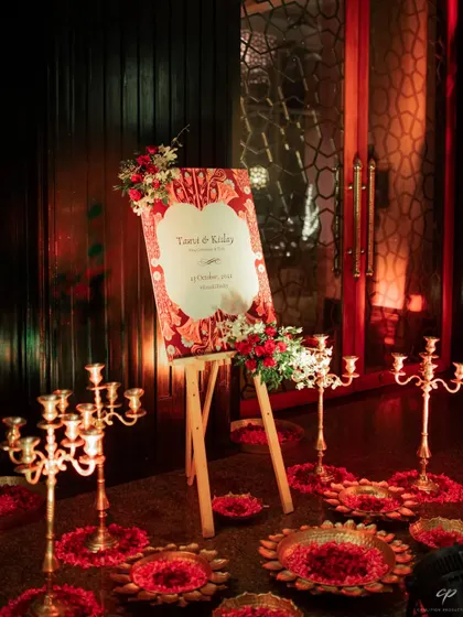 The welcome easel and decor being set up for a royal-themed engagement party.