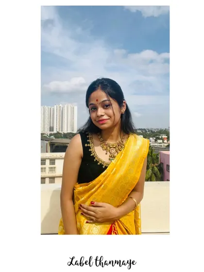 A client wearing the custom black velvet blouse with a yellow saree.