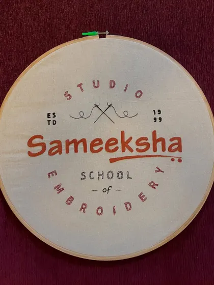 The finished embroidered logo, stretched in a hoop. It represents my 25-year journey with Sameeksha, a milestone I am very proud of.