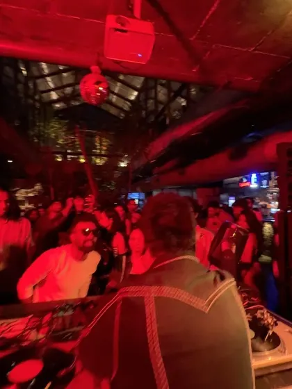 The red lights and disco ball create the perfect atmosphere for an old school vinyl set.