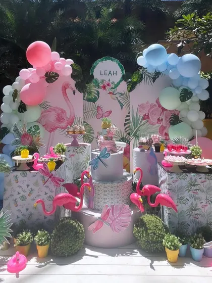Let's flamingle! A tropical flamingo-themed party with pink and blue balloon arches and plenty of flamingo friends to celebrate with.