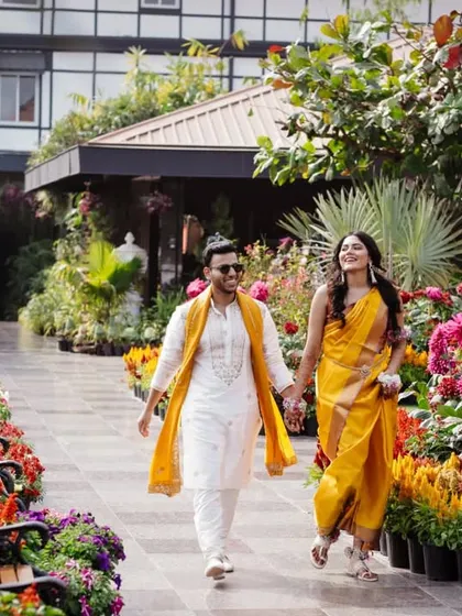 The couple taking a romantic walk through the gardens during their Haldi celebrations in Siliguri.