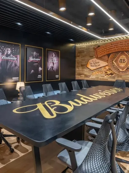 This Budweiser conference room is a great example of how I integrate a brand's identity directly into the workspace. The hand-painted logo on the table and the custom mural reflecting the brand's heritage create a powerful, immersive environment that's far more impactful than a simple logo on a wall.