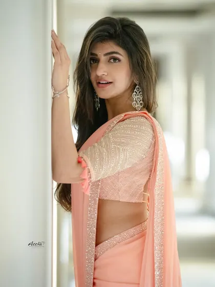 This portrait showcases the beautiful detailing on the blouse and the soft drape of the saree. The natural light gives the image a clean and airy feel.